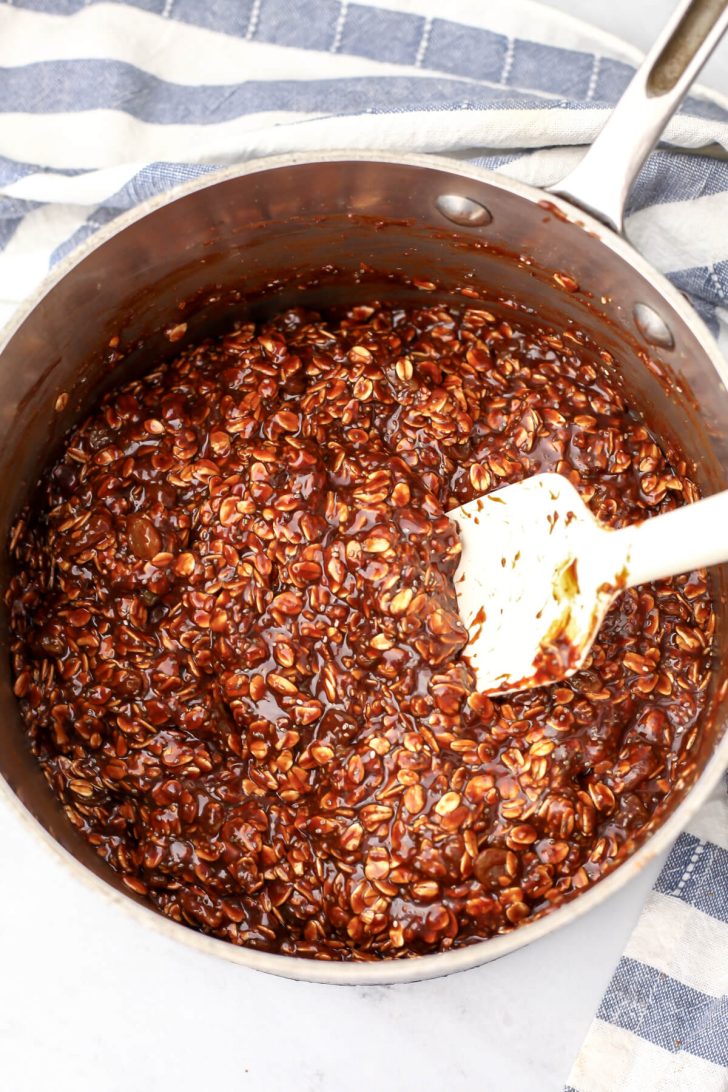 Almond butter no bake cookie mixture in a saucepan.