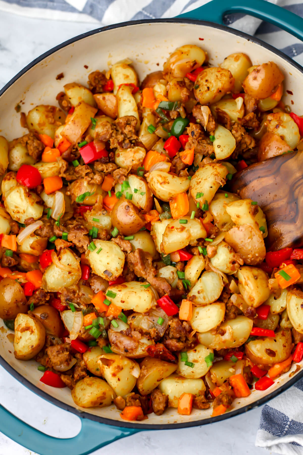 A top view of a vegan breakfast hash recipe made with onions, peppers, vegan breakfast sausage, and potatoes.