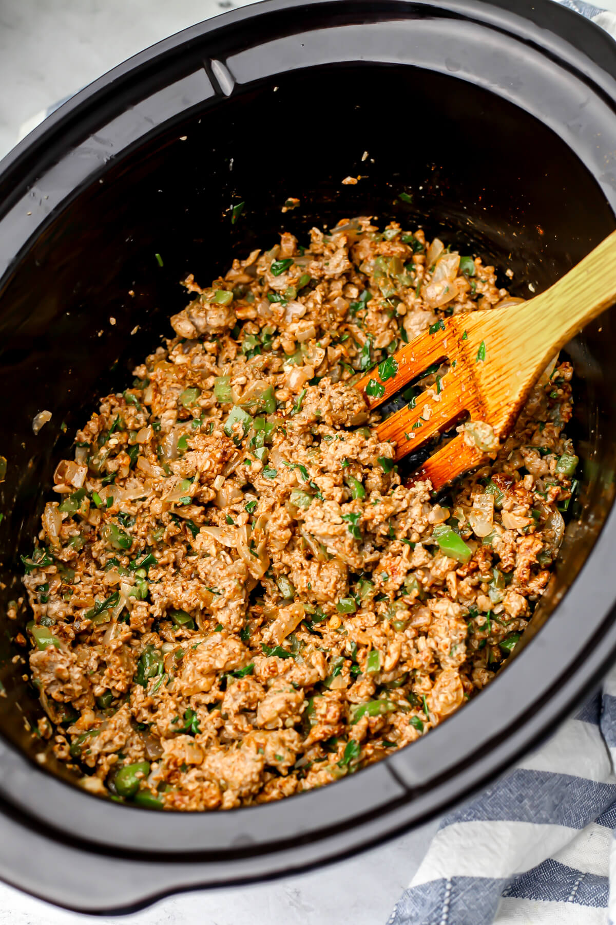 Vegan meat and veggies at the bottom of a slow cooker.