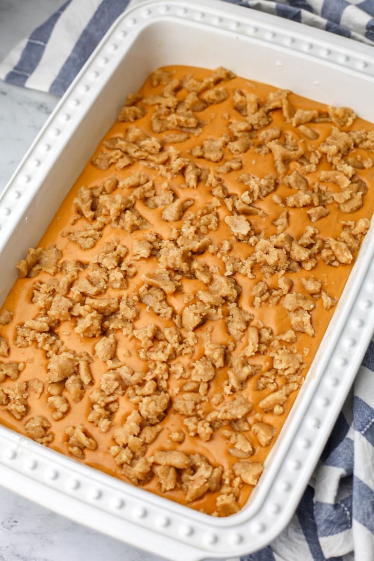The third layer of pumpkin pie cake added to the top of the pumpkin pie filling.