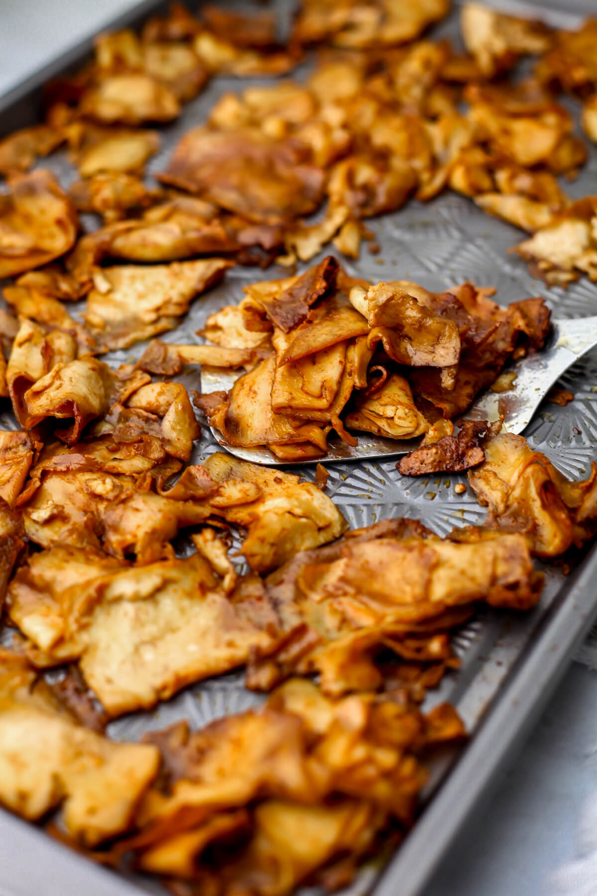 A sheet pan full of shaved marinated tofu roasted to make vegan deli meat out of tofu.