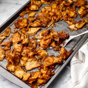 A sheet pan with shaved marinated tofu to make a vegan tofu deli meat.