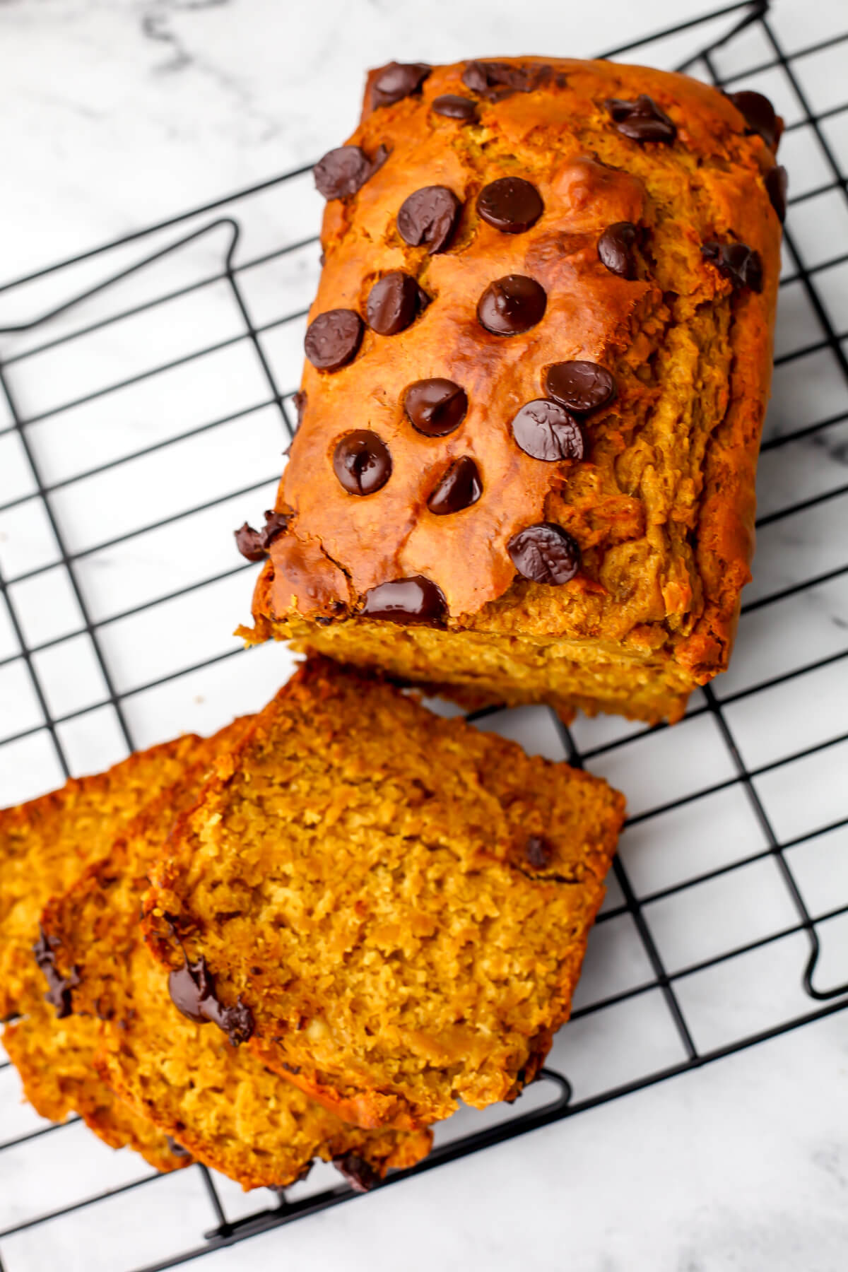 A top view of a vegan banana pumpkin bread with chocolate chips on top.