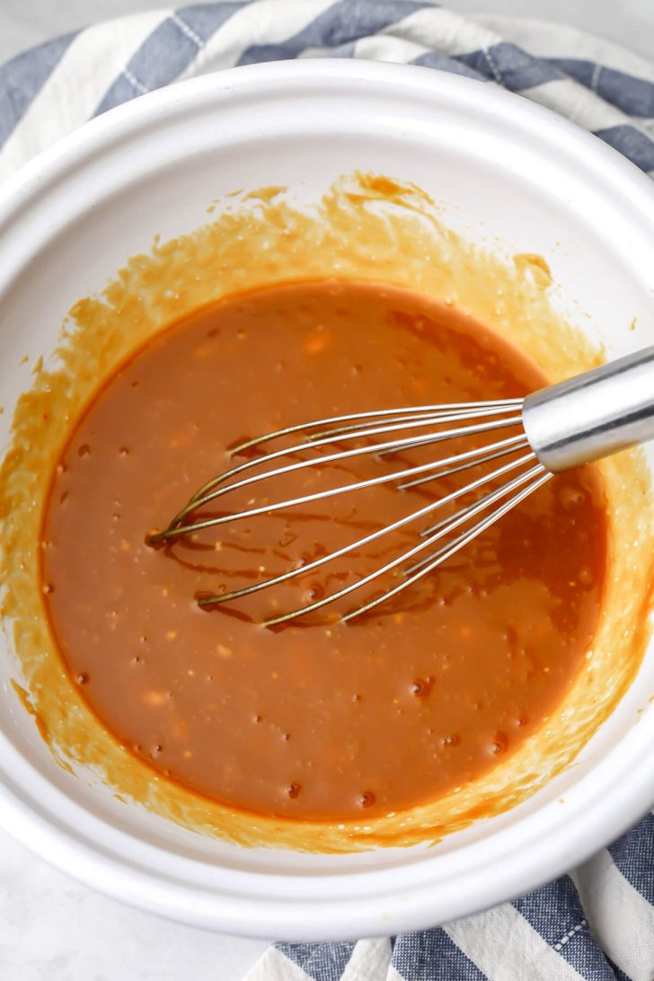 The wet ingredients for making vegan banana pumpkin bread in a white bowl.