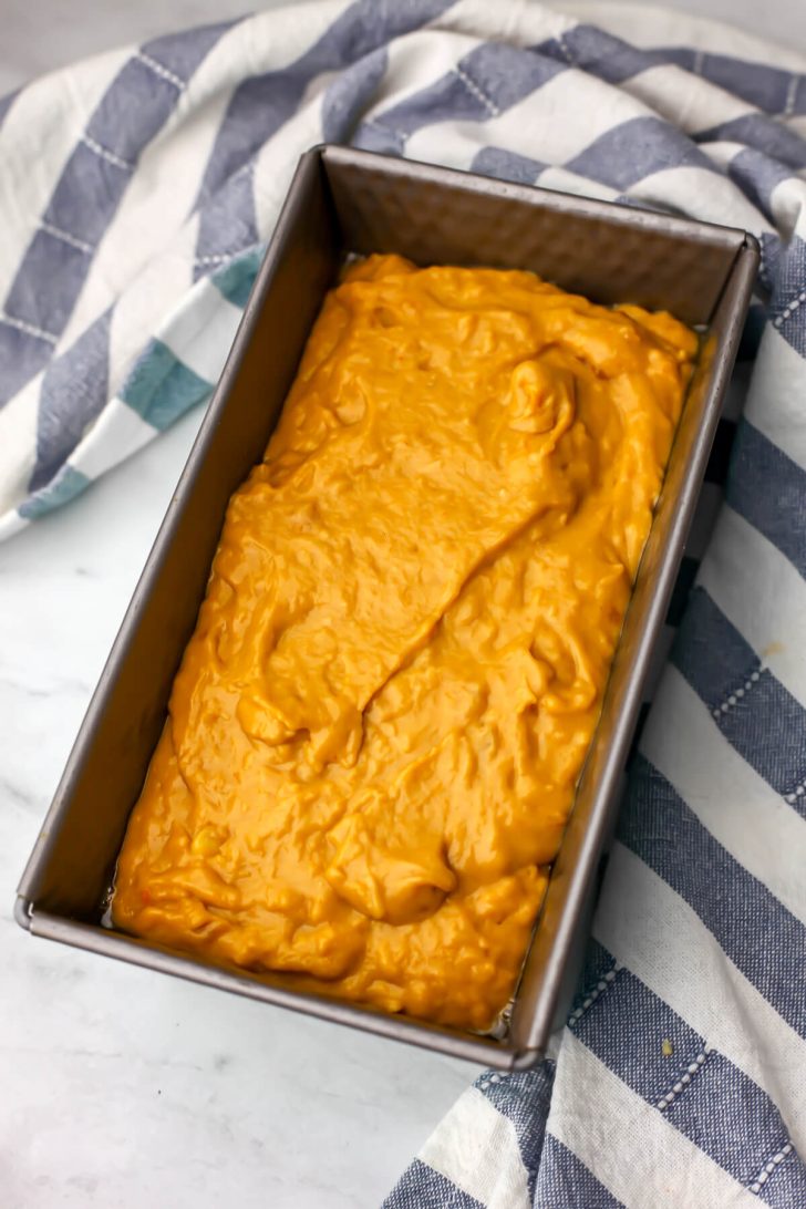 Vegan banana pumpkin bread batter in a greased bread tin.
