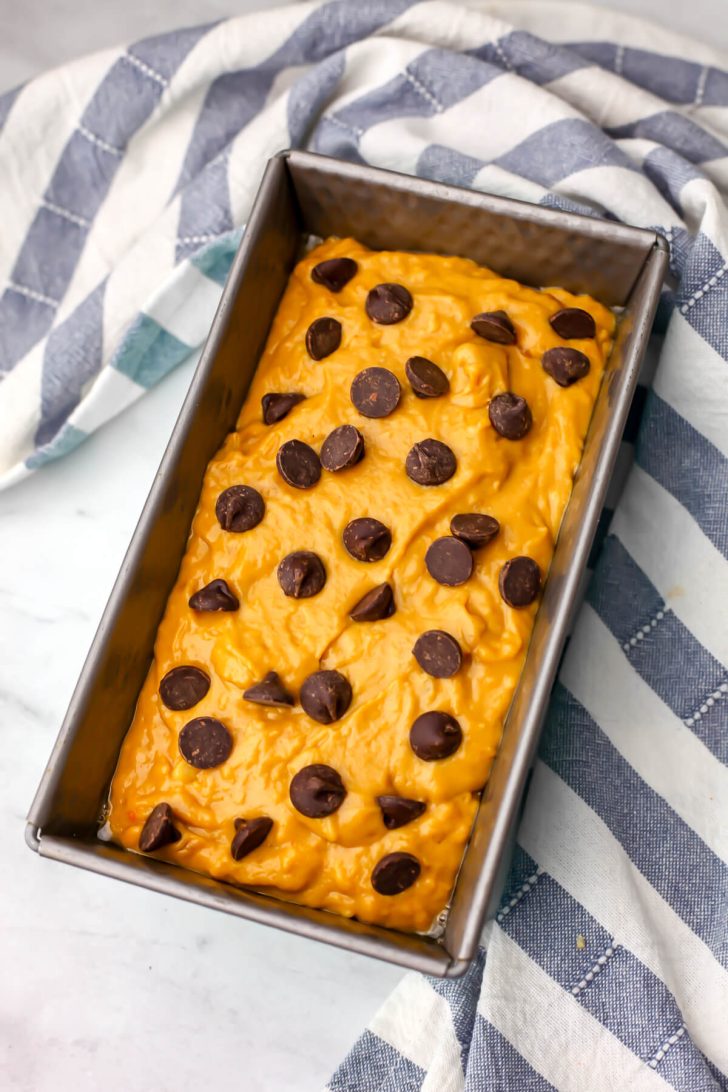Vegan banana pumpkin bread with chocolate chips on top before it bakes.