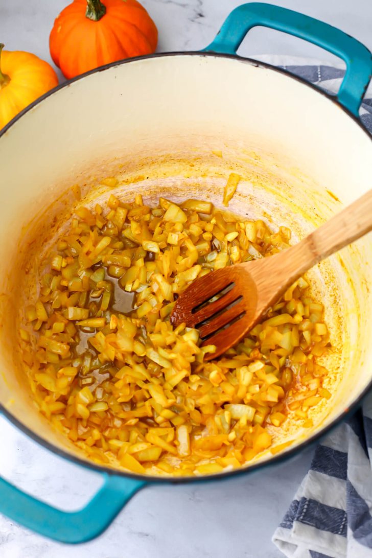 Onions, garlic, and spices sautéing in a soup pot.