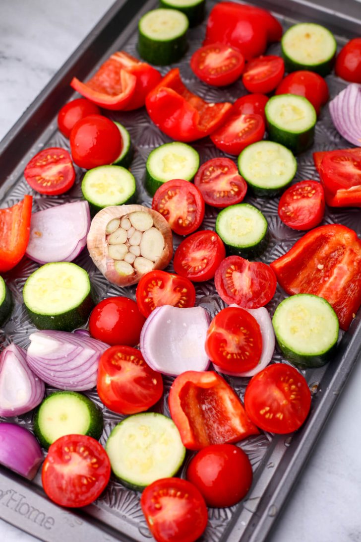 Vegetables cut into chunks an placed on a sheet pan with olive oil and salt.