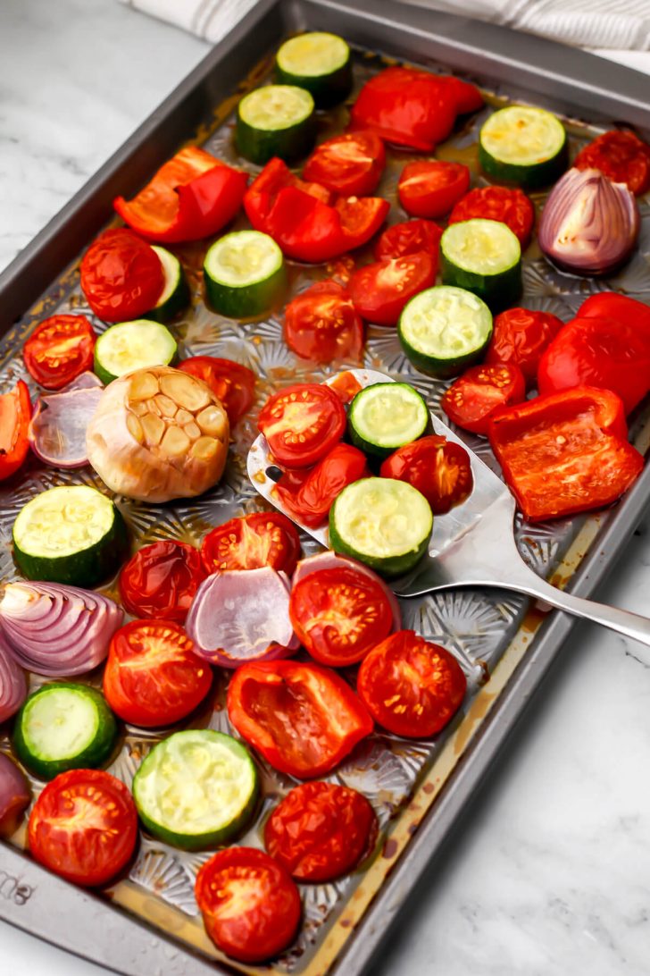 Vegetables on a sheet pan after they have roasted to make roasted vegetable pasta sauce.