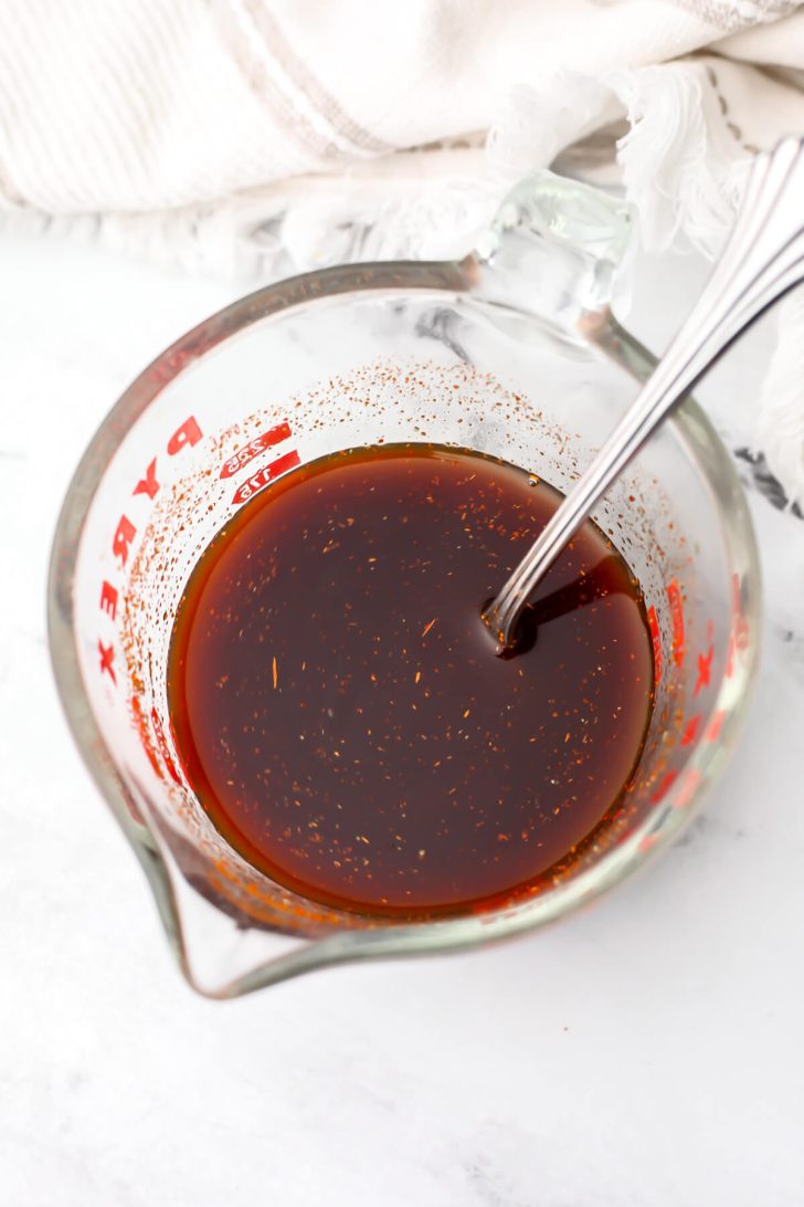 Tofu marinade mixed in a glass measuring cup.