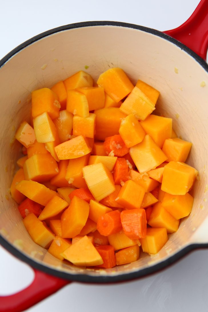 Cubed butternut squash added to a saucepan.