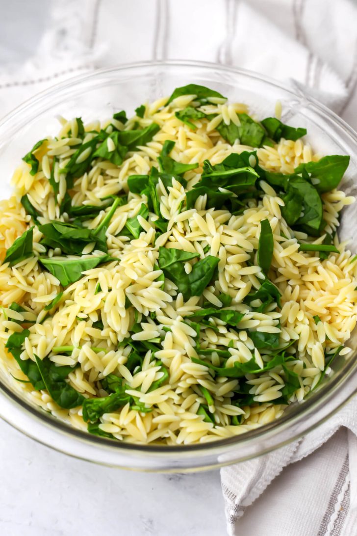Hot orzo mixed with baby spinach.
