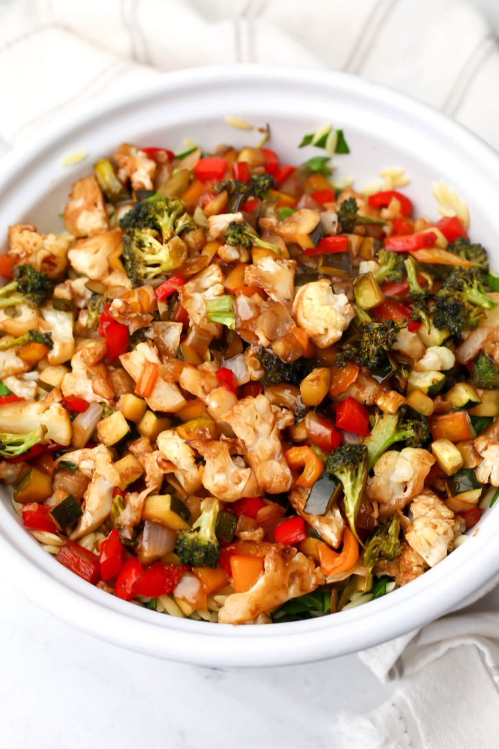 The roasted vegetables on top of the orzo and spinach.