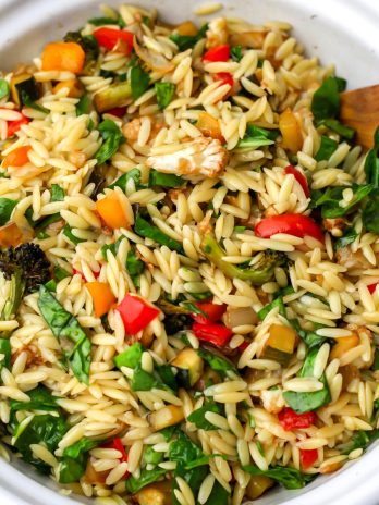 A top view of a bowl of roasted vegetable orzo salad.