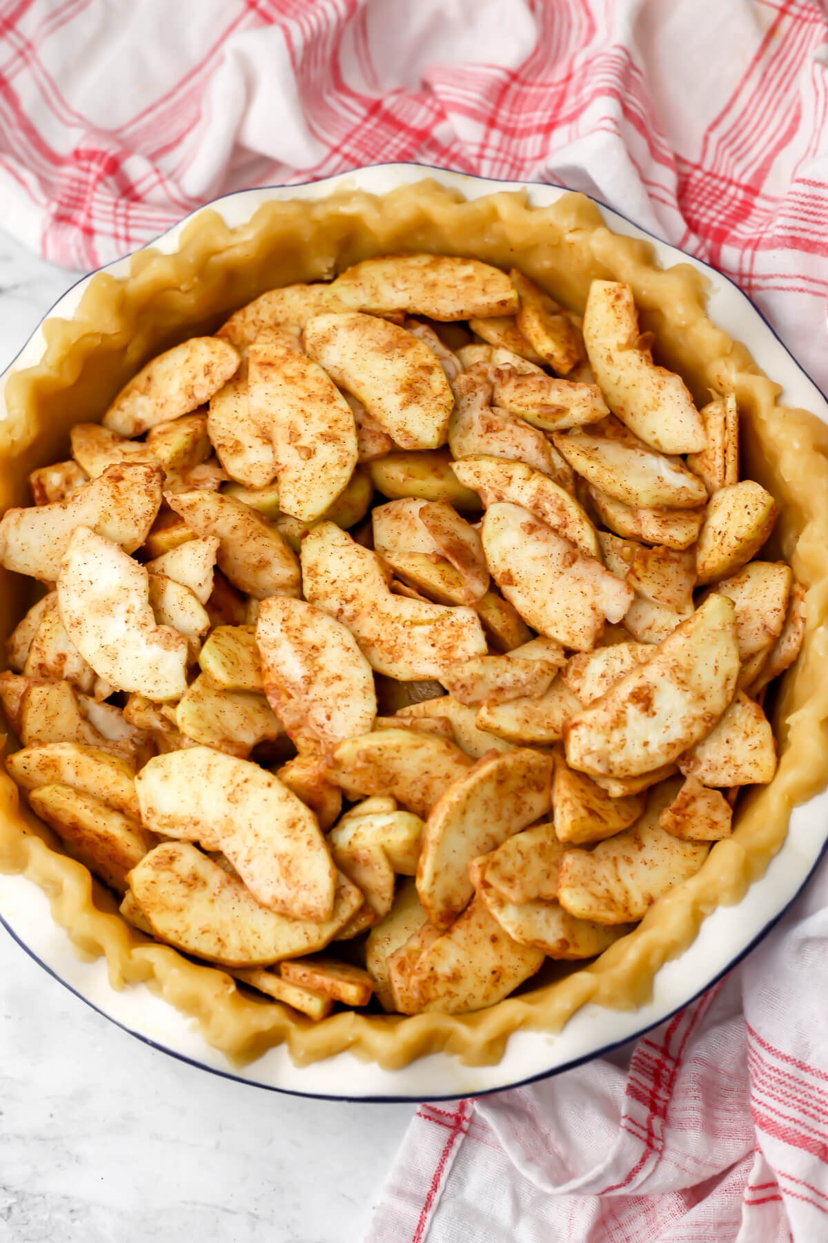 A vegan Dutch apple pie before the crumble topping is sprinkled on top.