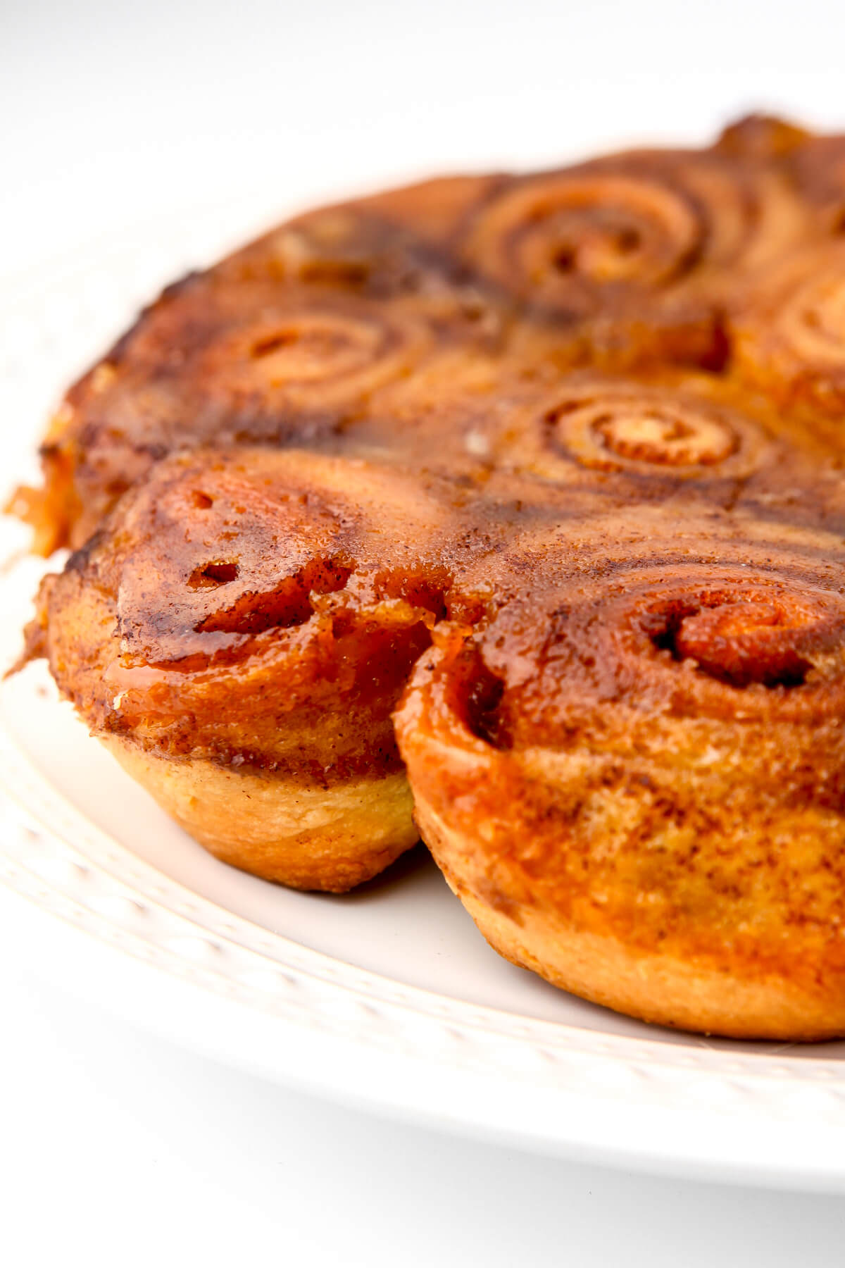 A white plate full of vegan sticky buns.