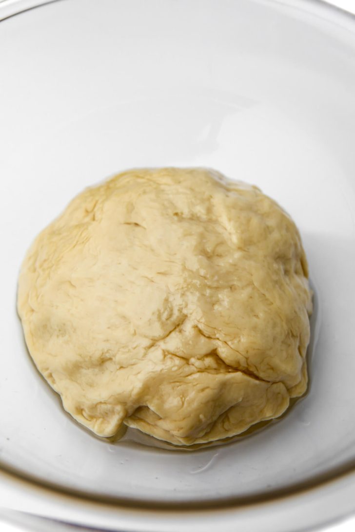 A ball of oiled dough to make vegan sticky buns.