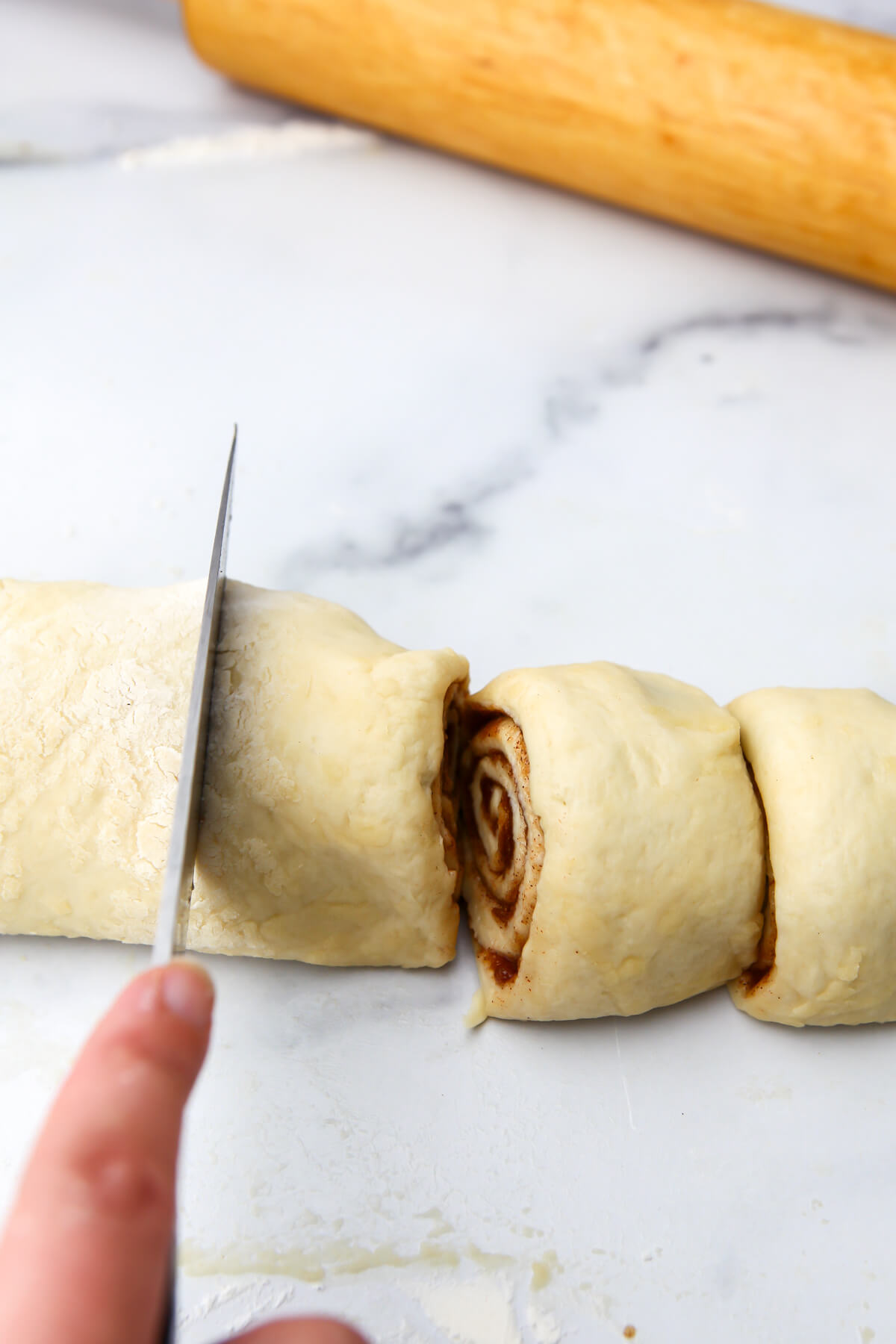 Cutting the dough into sticky buns.