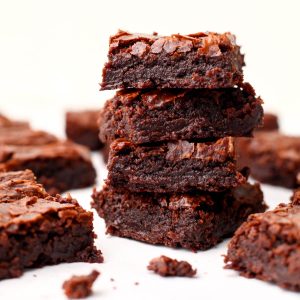 Fudgy vegan brownies made from a boxed mix on a white countertop.