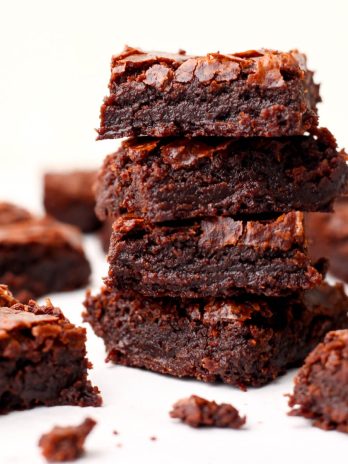 Fudgy vegan brownies made from a boxed mix on a white countertop.
