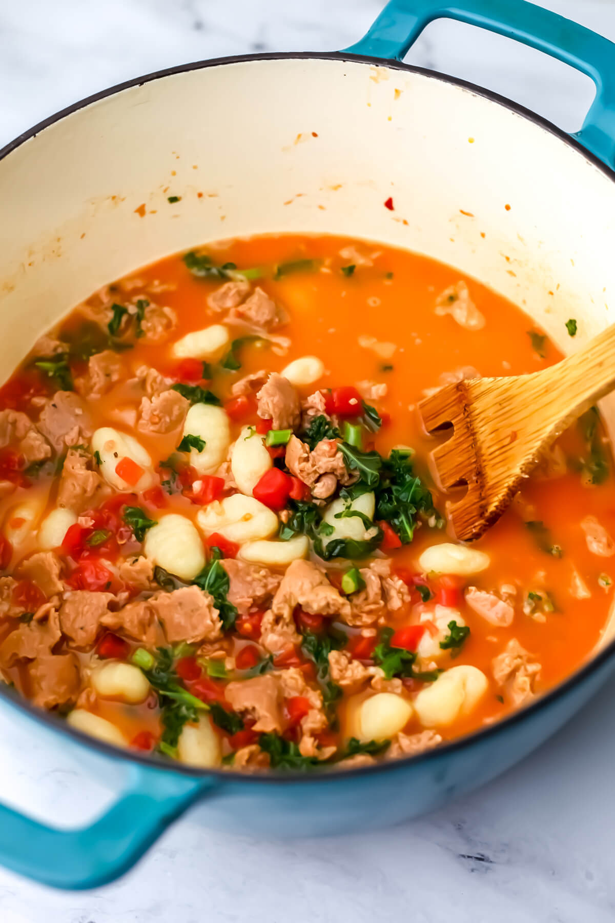 Vegan gnocchi soup with sausage and kale before the cream has been added.