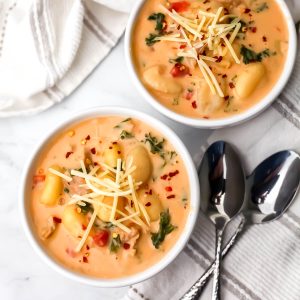 A top view of two bowls of creamy vegan gnocchi soup.