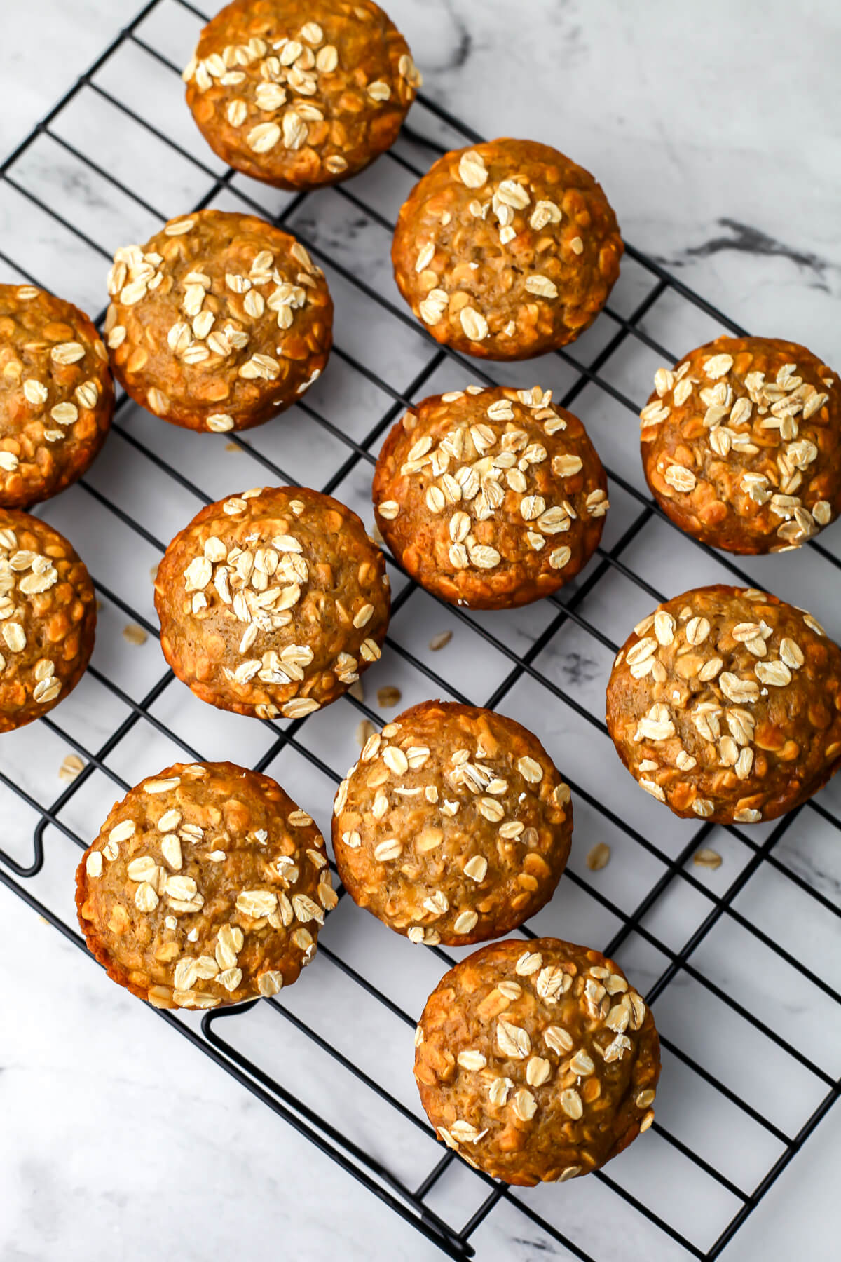 A top view of vegan oat muffins with whole oats sprinkled on top.