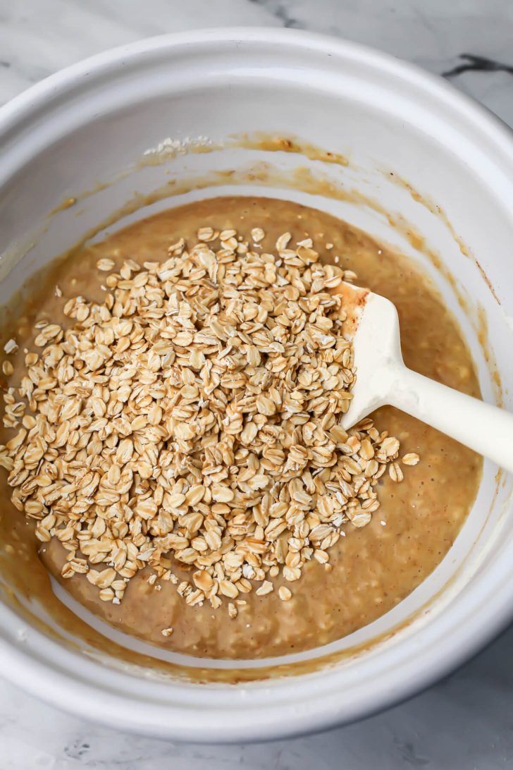 Oats added to the batter to make vegan oat muffins.