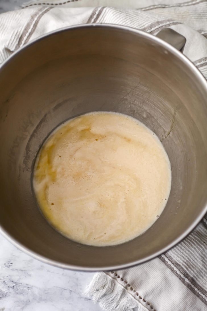 Yeast proofed in a bowl with sugar, salt, and melted vegan butter to make soft pretzels.