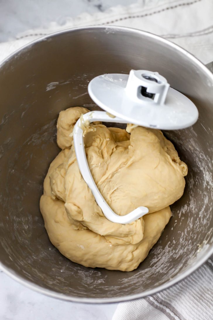 Vegan soft pretzel dough in a mixing bowl with a dough hook.