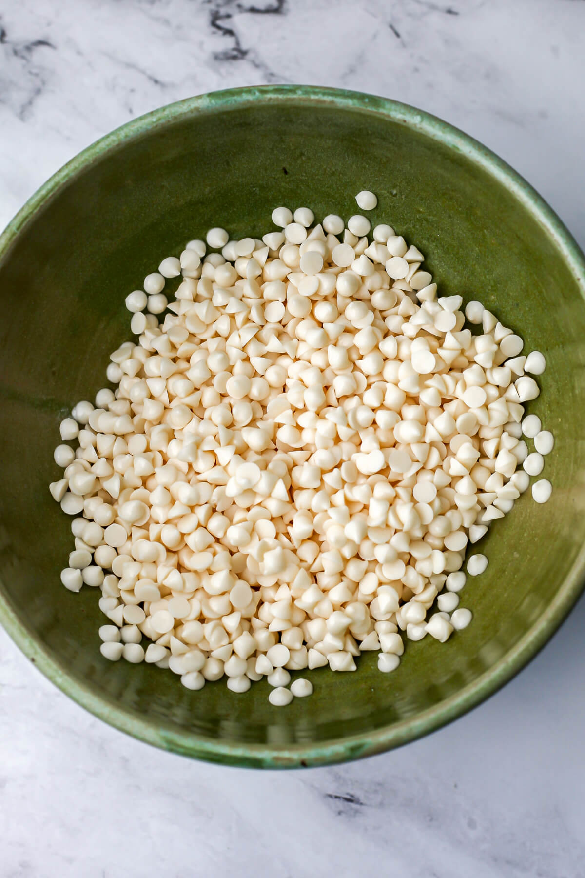 A bowl of vegan white chocolate chips.