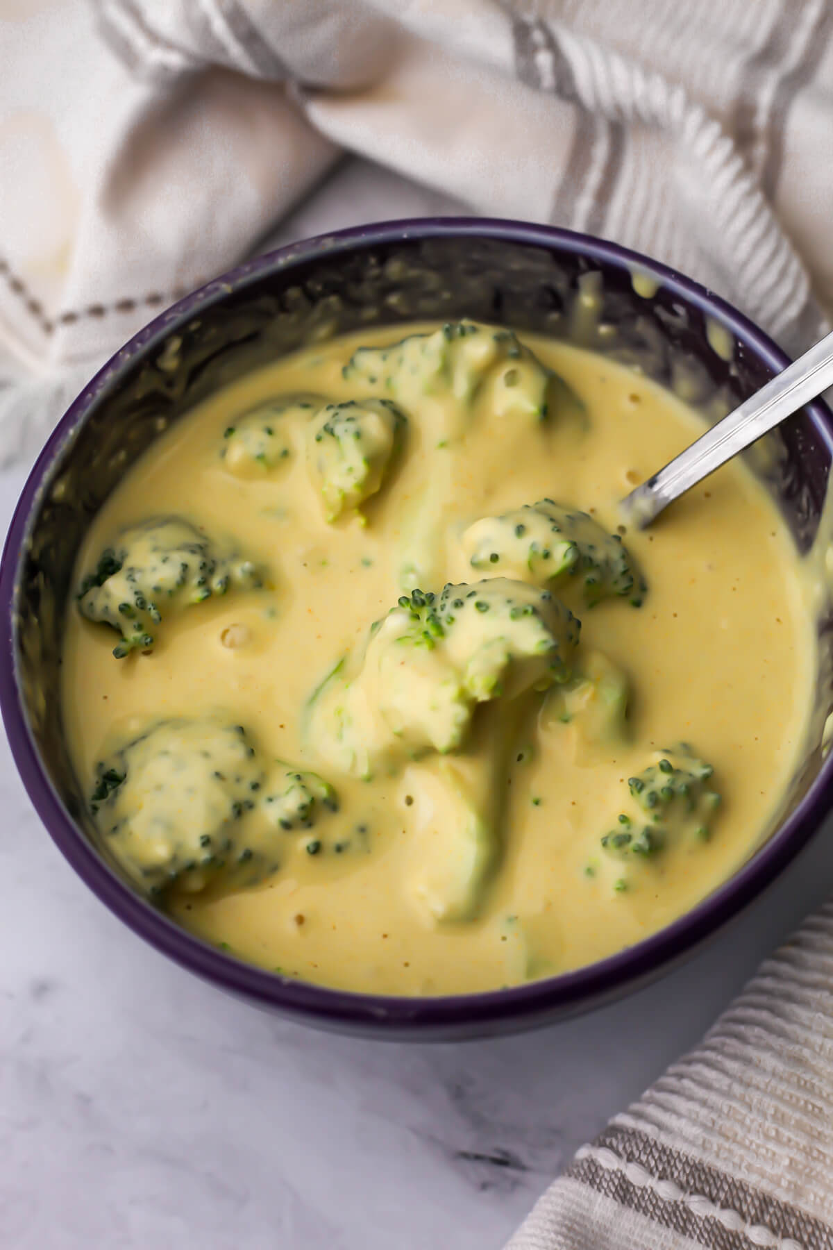 Broccoli florets that are covered with batter before frying.