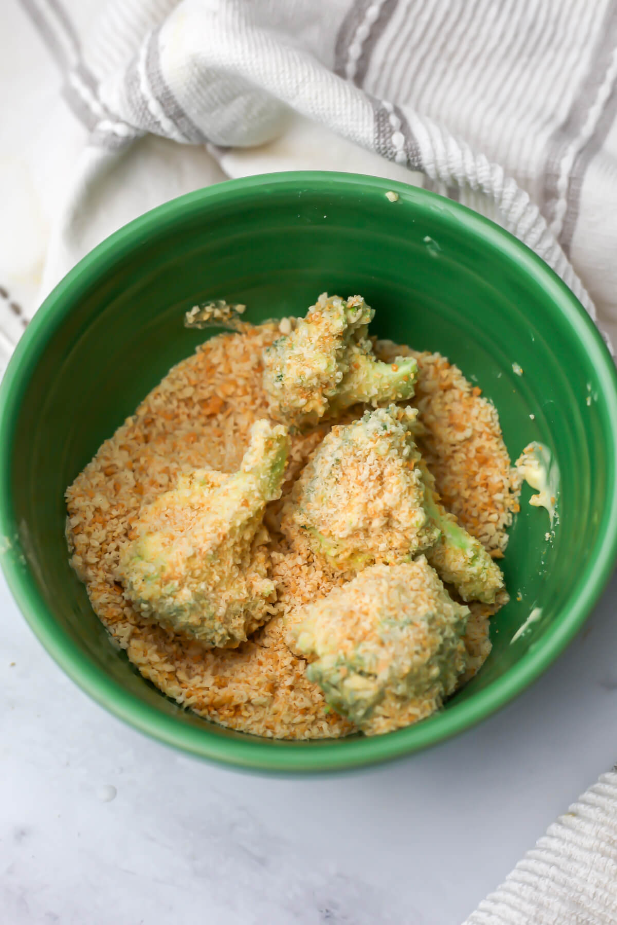 Broccoli florets covered in batter then rolled in panko bread crumbs before frying.