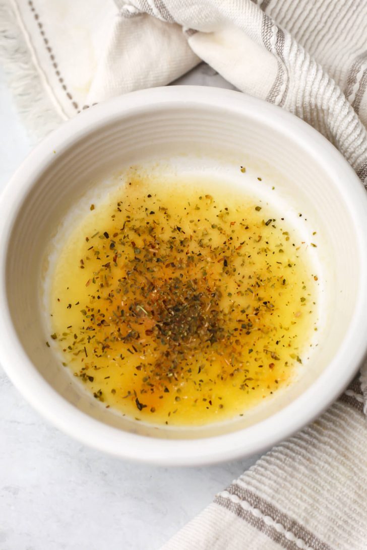 Melted vegan butter with spices added to it to make seasoned breadcrumbs.