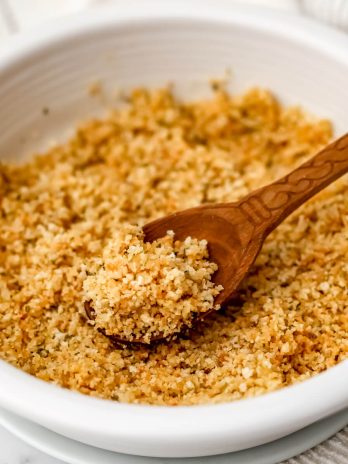 A white bowl filled with seasoned vegan breadcrumbs.