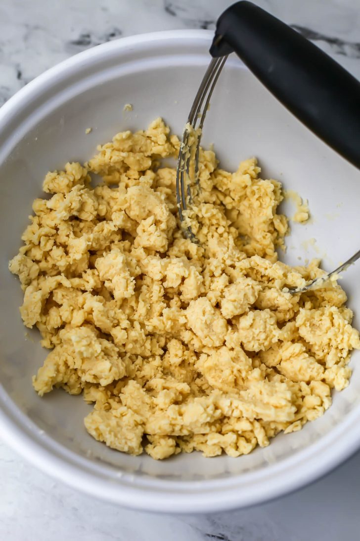 The vegan shortbread mixed with a pastry cutter.