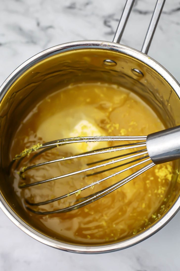 Vegan lemon curd after simmering with butter and lemon zest added.