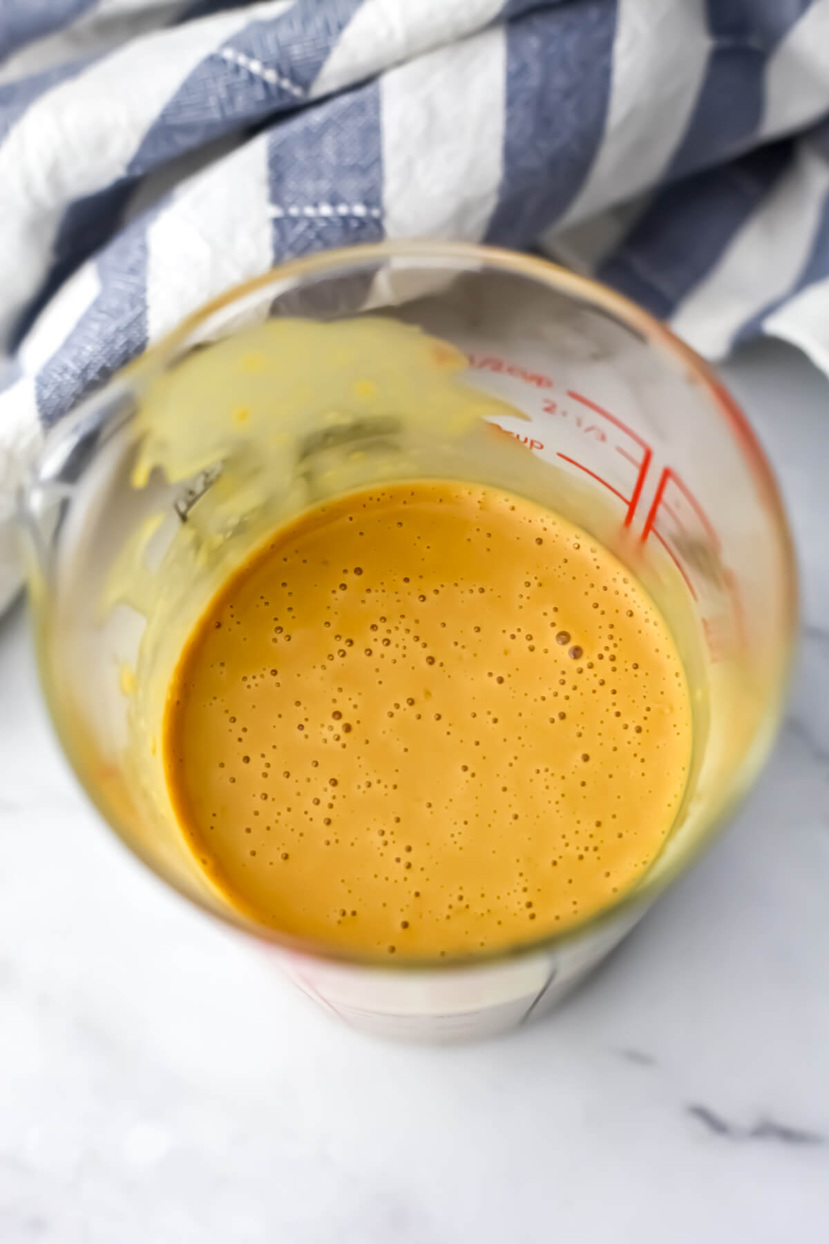 A top view of the nutritional yeast dressing after it has blended.