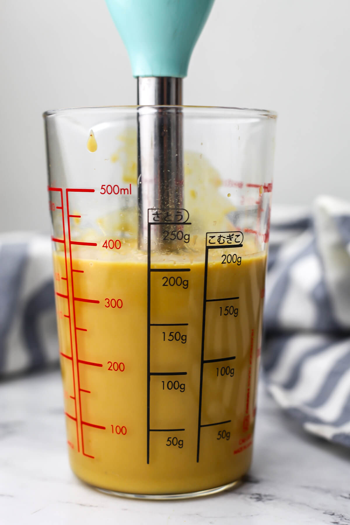Nutritional yeast dressing in an immersion blender after blending.