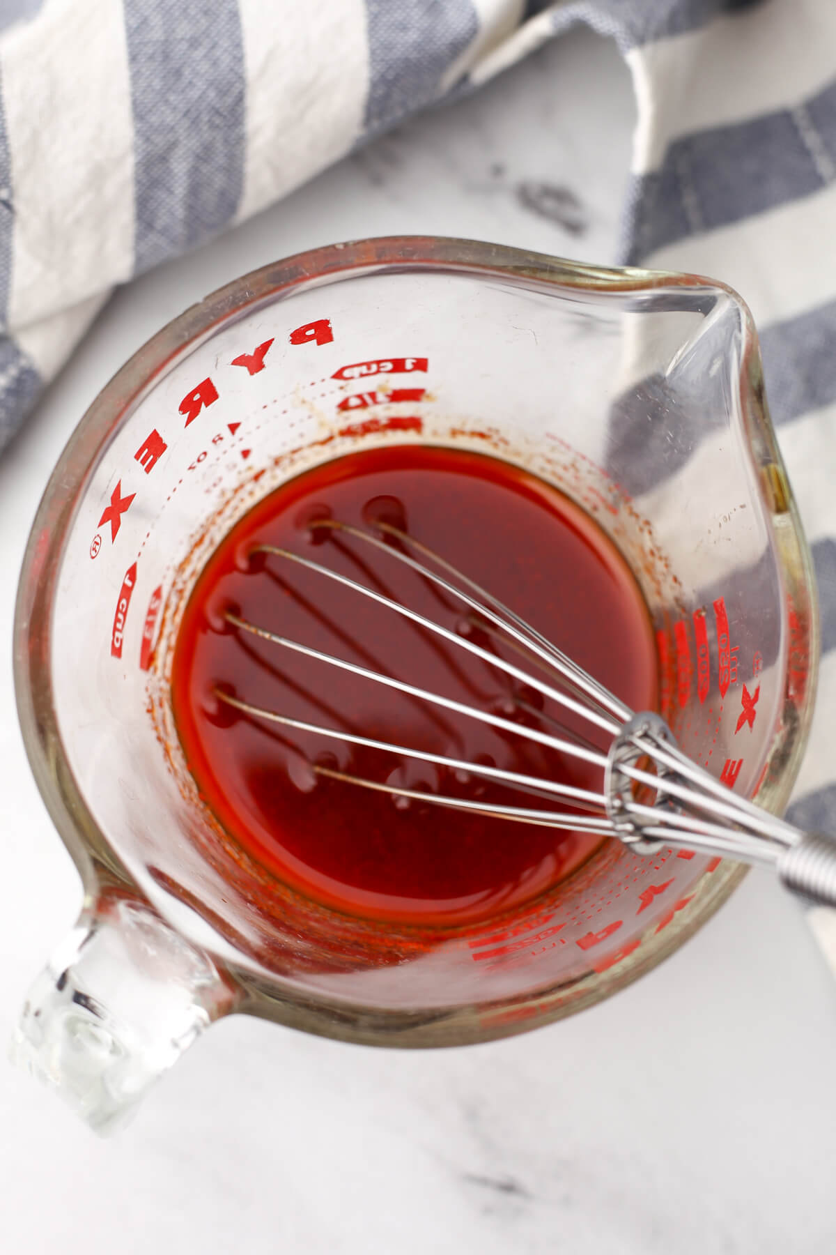 Mixing the smoky tofu marinade with a small wire whisk.