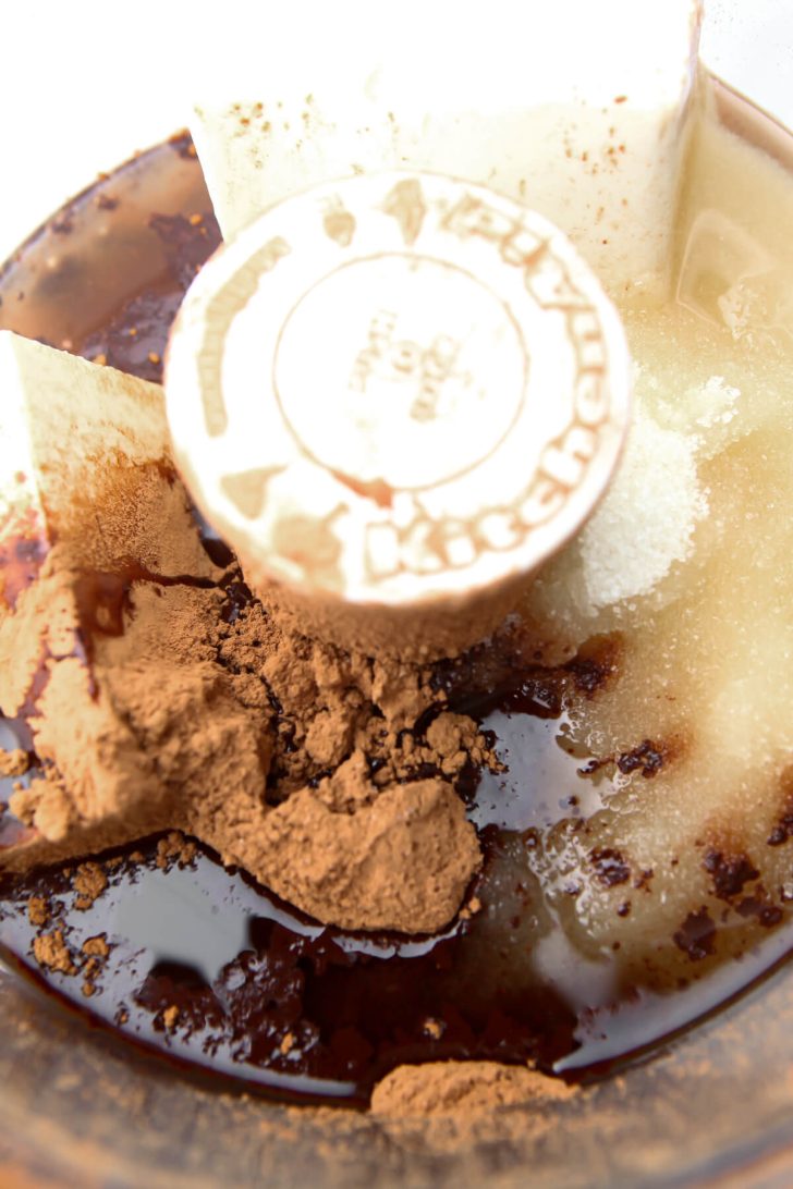 Tofu chocolate, coconut oil, and sugar in a food processor to make a vegan chocolate tofu pie.