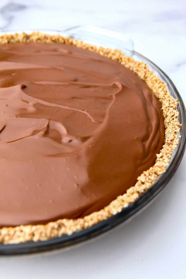 Vegan chocolate pie in a pie dish with a vegan crumb crust.