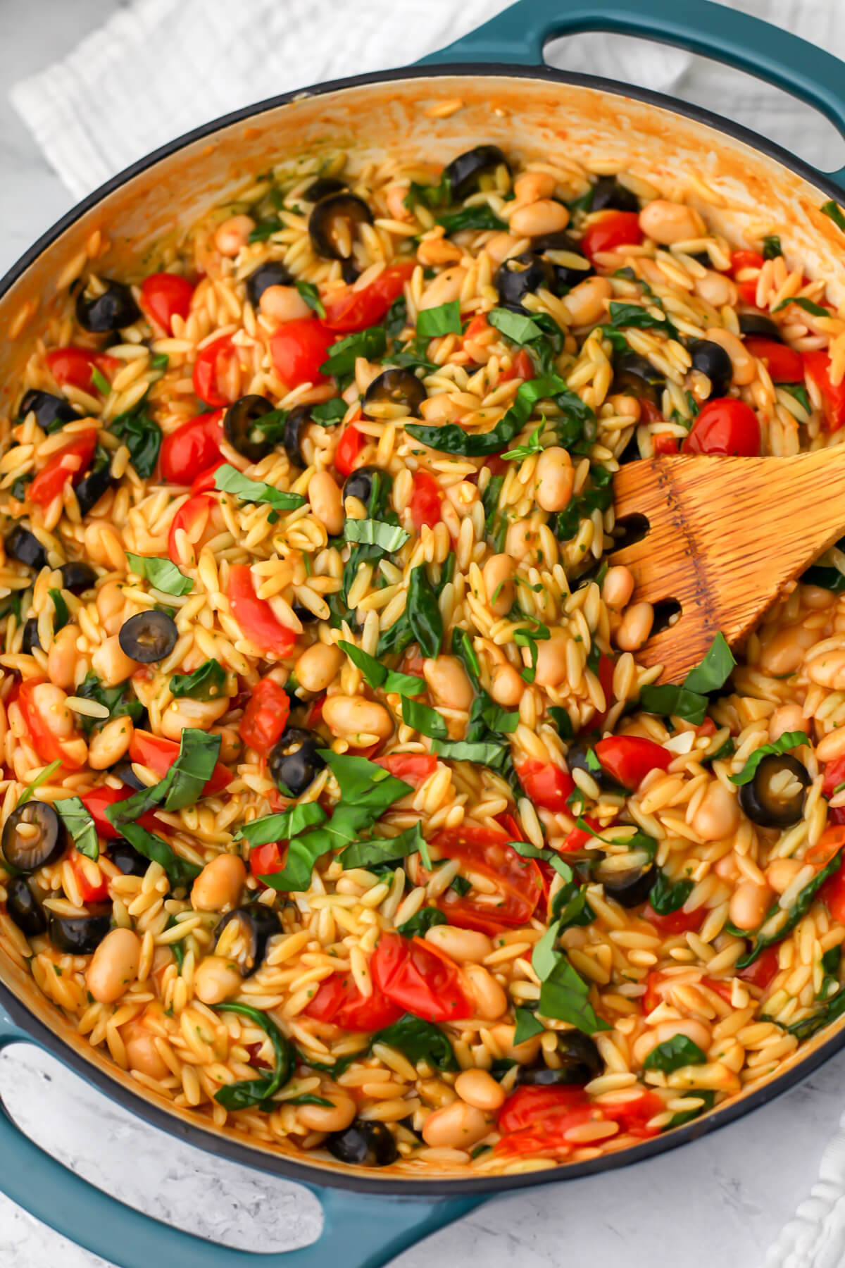 Cherry tomato orzo with white beans, spinach, and black olives.