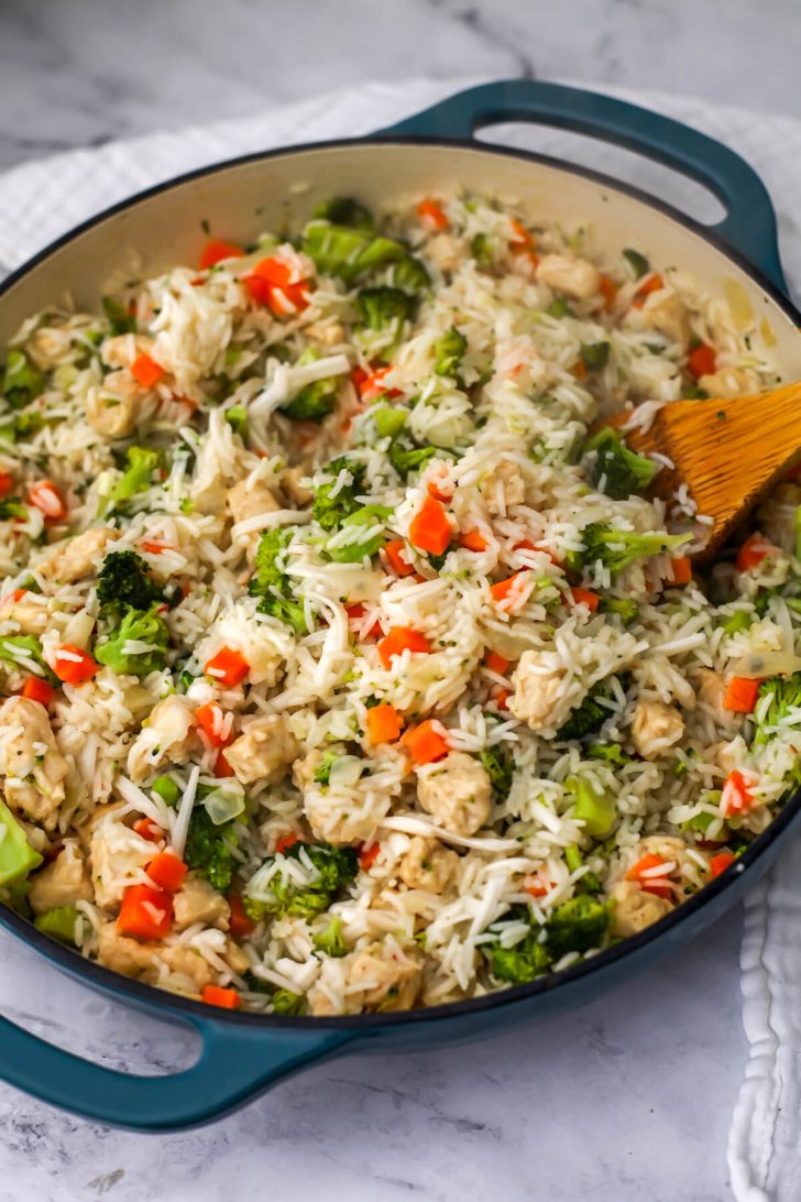 Cooked rice with vegan chicken, broccoli and cheese.