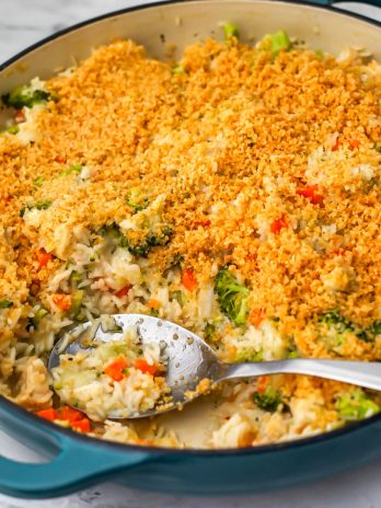 A blue skillet filled with a vegan chicken broccoli and rice dish topped with garlic breadcrumbs.