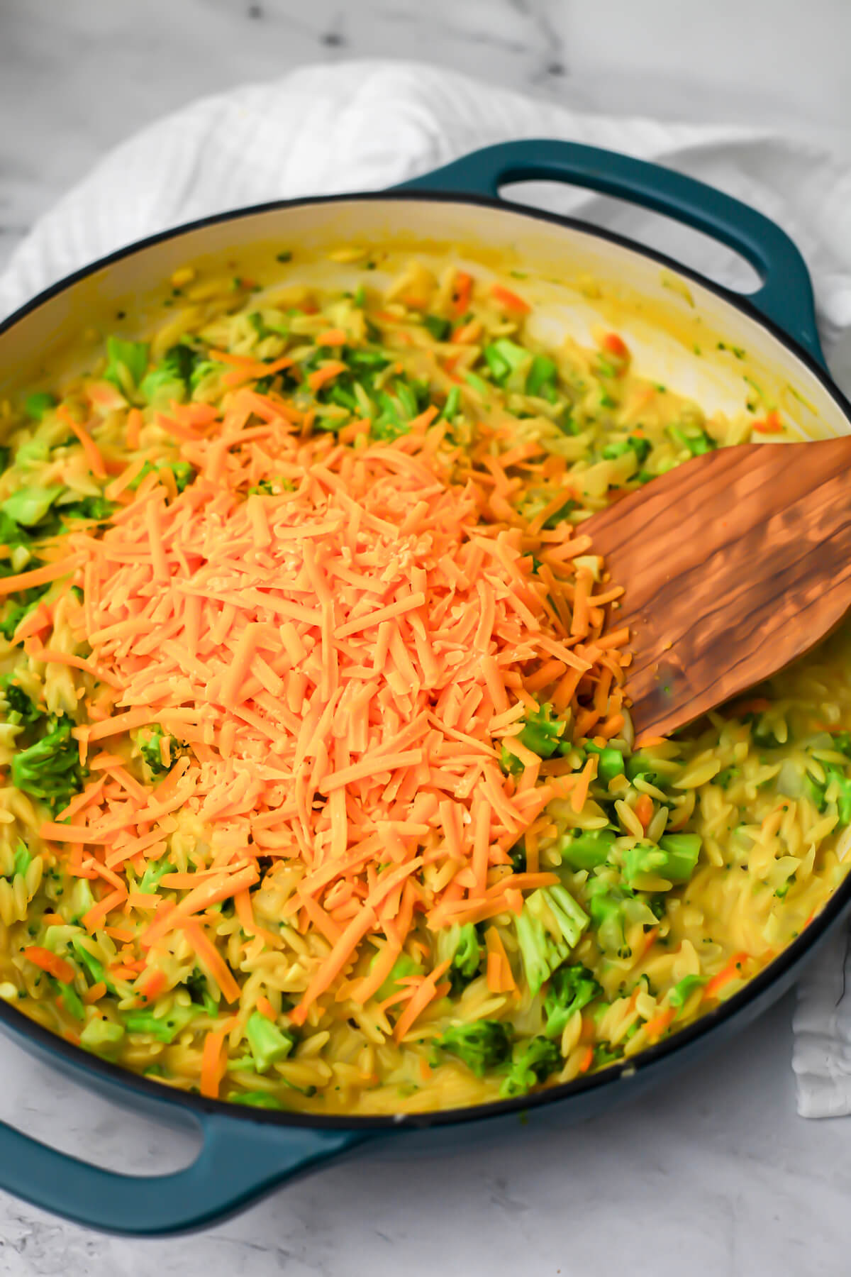 Vegan cheddar shreds added to the broccoli and orzo.